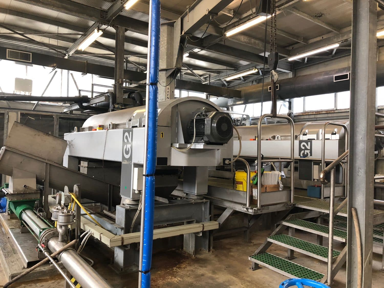 Dewatering room at the Comodepur plant: decanter centrifuges and cake removal by screw conveyor